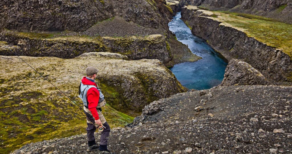Fisherman looking into a deep canyon