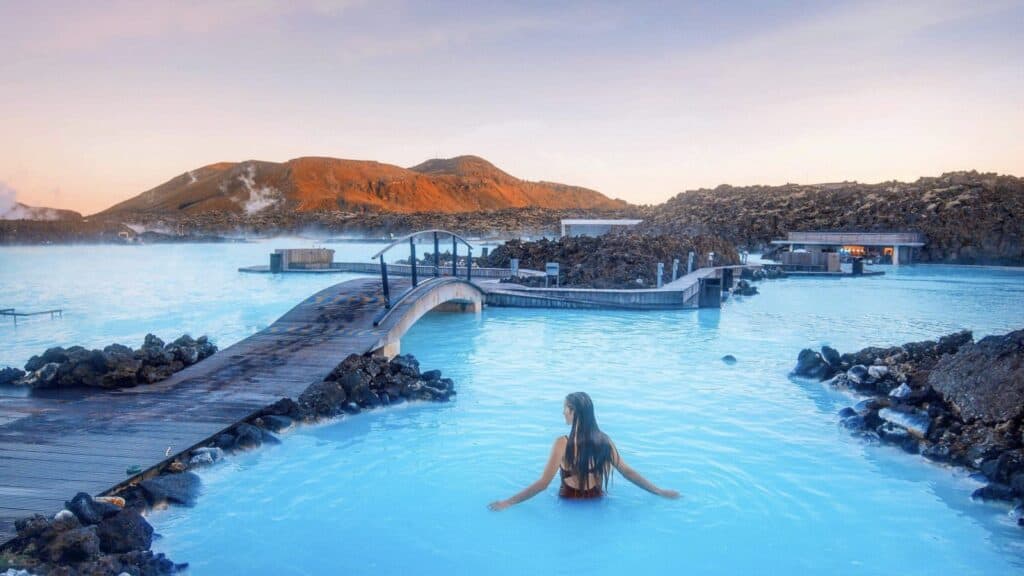 Natural geothermal hot spring in Iceland, steaming and surrounded by volcanic landscape, perfect for relaxation.