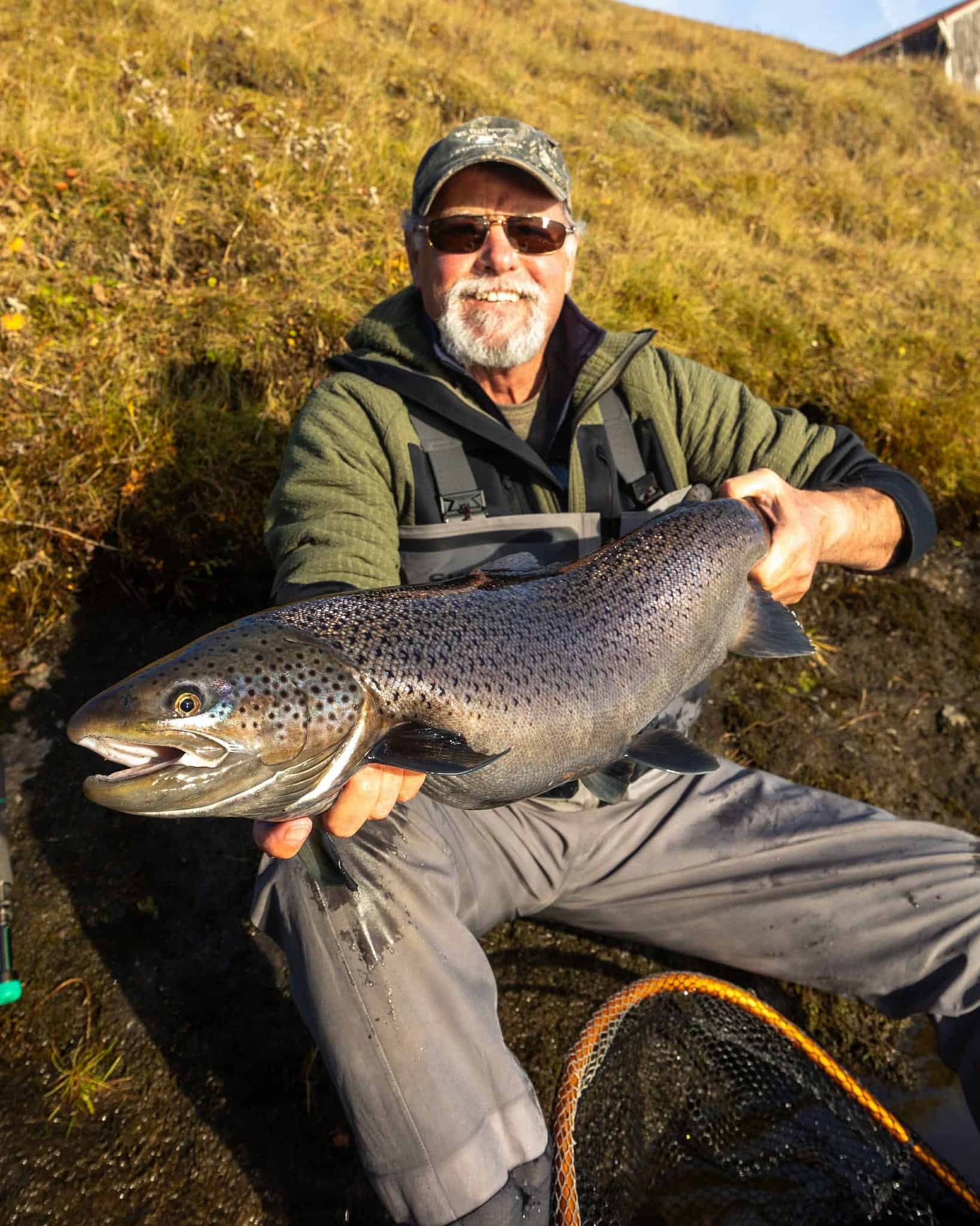 Large rainbow trout caught on a fishing trip, showcasing freshwater angling success.