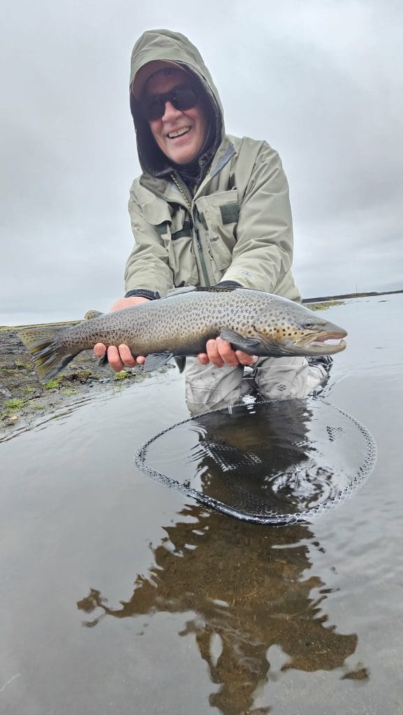 Caught big fish during freshwater fishing in outdoor nature setting.