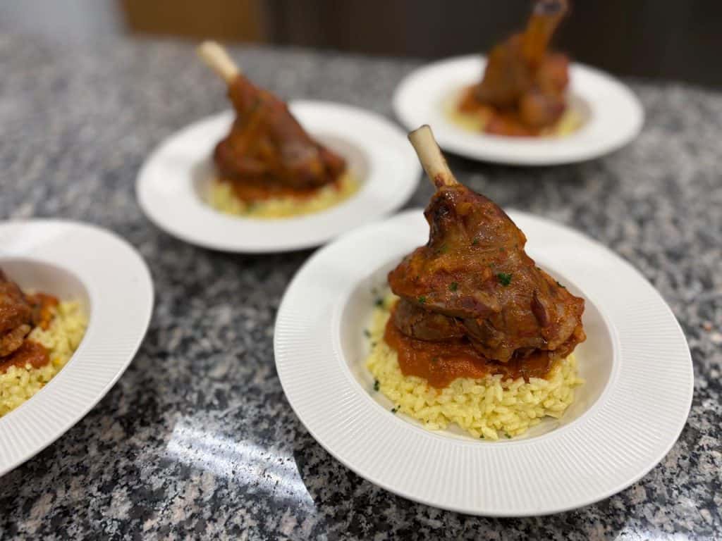 Delicious fish dish served with rice on a white plate.