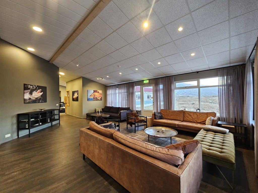 Spacious lodge lounge with comfortable seating and large windows.
