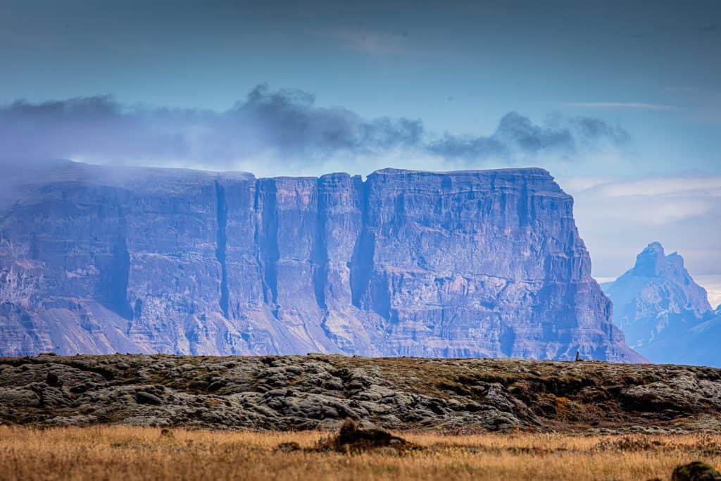 Spectacular view of towering cliffs with a cloudy sky in the background.