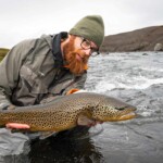 The Northern Highlands fly fisherman holding a big brown trout