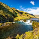 Beautiful Iceland river with waterfalls and scenic green surroundings, ideal for fishing and nature exploration. Fish partner, fishing, river, Iceland, nature, freshwater, outdoor, fishing destination, scenic landscape, river fishing, eco-friendly, sustainable fishing, adventure, travel, wilderness.
