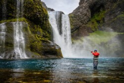 Waterfall and fly fisherman
