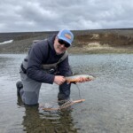 Flyfisherman holding an arctic char