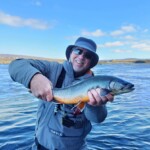 Flyfisherman holding an arctic char