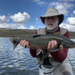 Fly fisherman holding a arctic char