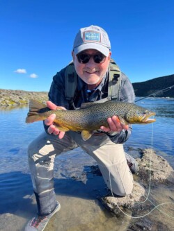 Highland Fishing Man holding a brown trout