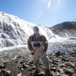 Enjoying a day of fishing at a scenic waterfall, emphasizing outdoor and freshwater fishing activities. Caught fishing near a waterfall, enjoying outdoor adventure and freshwater angling.