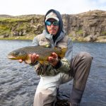 Freshwater fishing in Iceland with a rainbow trout catch, outdoor fishing adventure. Rainbow trout caught while fishing in Iceland, showcasing freshwater fishing success.
