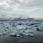 Majestic icebergs float in the icy waters near a glacier in Iceland, showcasing natural cold beauty. Melting glacier with floating icebergs in a cold arctic landscape, Icelandic scenery.