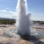 Geyser eruption in a geothermal field, showcasing natural hot springs and water jets. Fountain geyser erupting outdoors in a geothermal area.