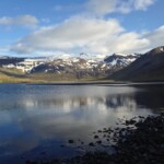 Scenic Icelandic landscape with mountains and lake, perfect for aquaculture, fish farming, and sustainable seafood. Snow-capped mountains reflecting in a serene lake in Iceland, ideal for fish farming and aquaculture.