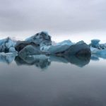 Majestic glaciers and icebergs in polar waters highlight pristine environments for sustainable fishing. Glaciers and icebergs floating in icy Arctic water for sustainable fishery practices.