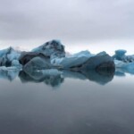 Majestic glaciers and icebergs in polar waters highlight pristine environments for sustainable fishing. Glaciers and icebergs floating in icy Arctic water for sustainable fishery practices.