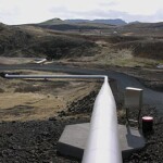 Geothermal pipeline installation in volcanic terrain for renewable energy projects. High-altitude geothermal energy pipeline in volcanic landscape for sustainable power generation.