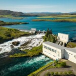 Hydropower facility generating clean energy amidst scenic nature with dam and water bodies. Hydropower dam and water reservoir in a lush green landscape, renewable energy source.